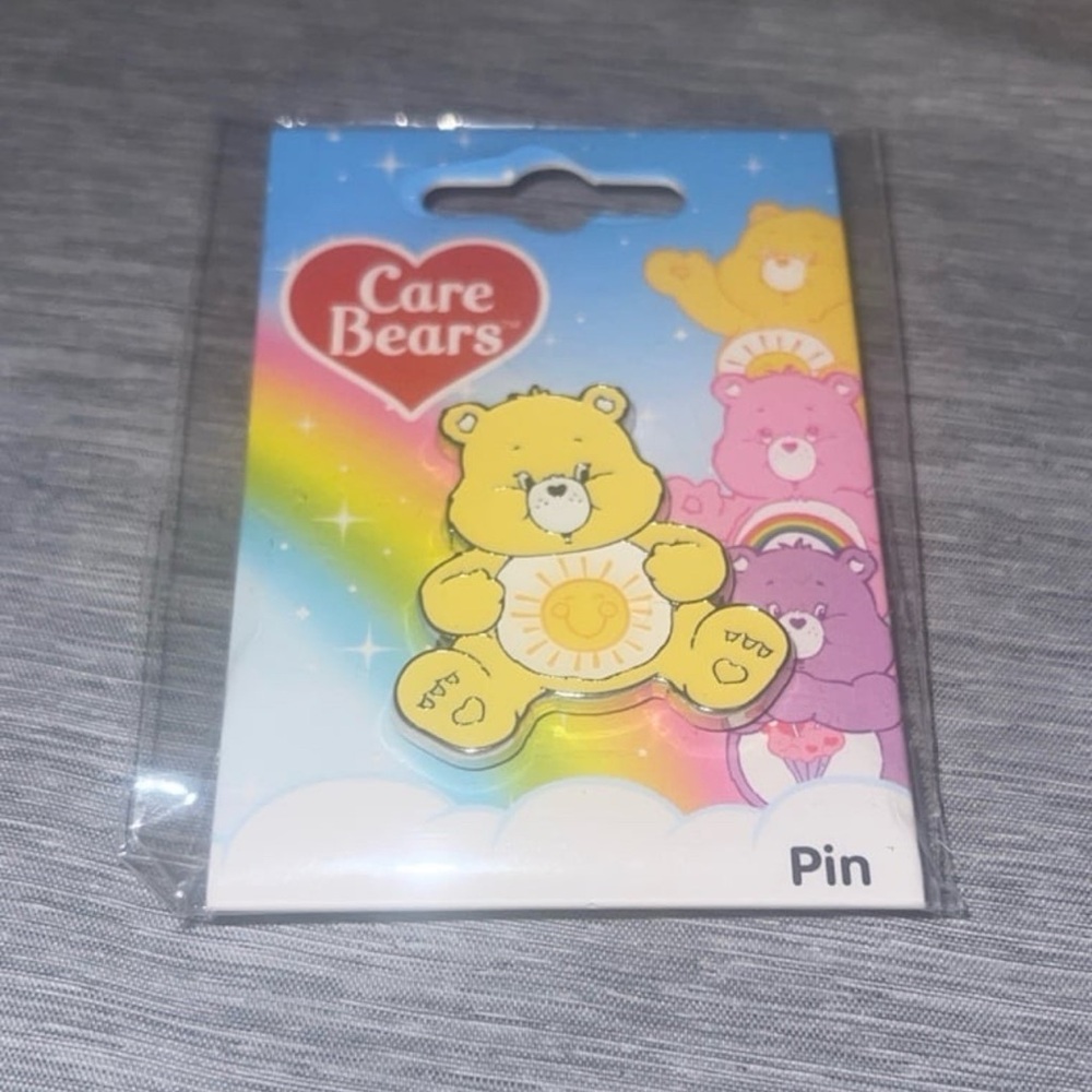 Yellow care bear pin